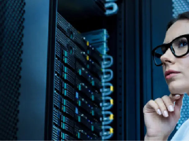 A woman observes a server rack closely, highlighting focus on IT infrastructure and data security.